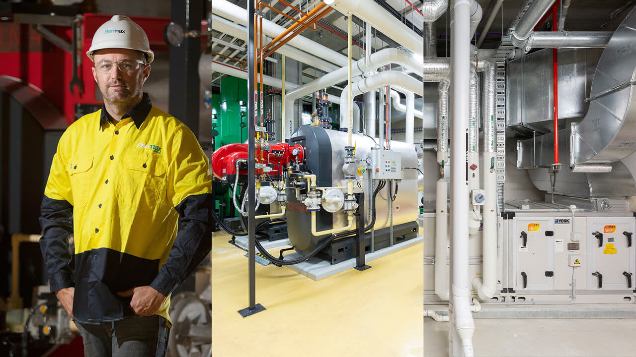 Benmax employee standing in front of industrial machine.