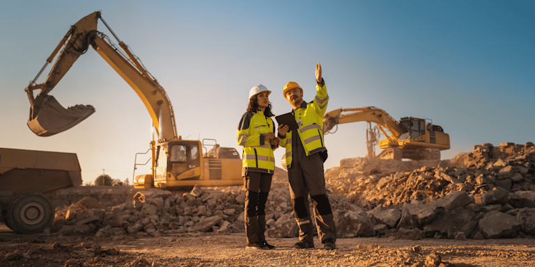 Two construction workers in discussion on site