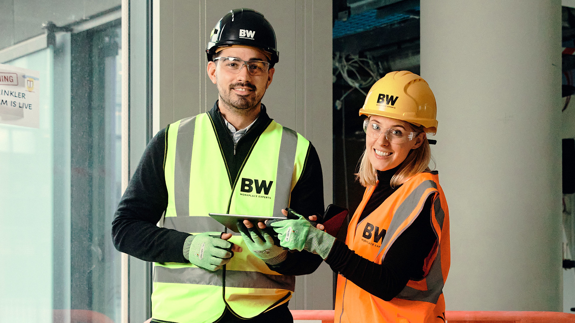 Contractors smiling to the camera, wearing safety equipment