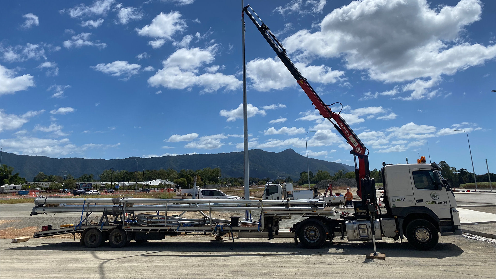 A truck with a crane on a trailer