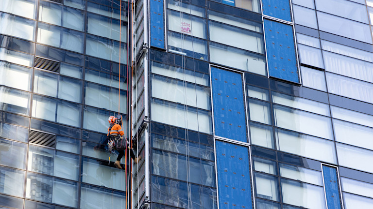 Picture of RM Watson construction worker on the side of a building