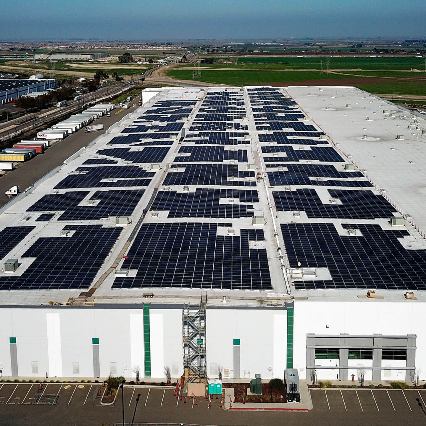 A warehouse with solar panels on its roof