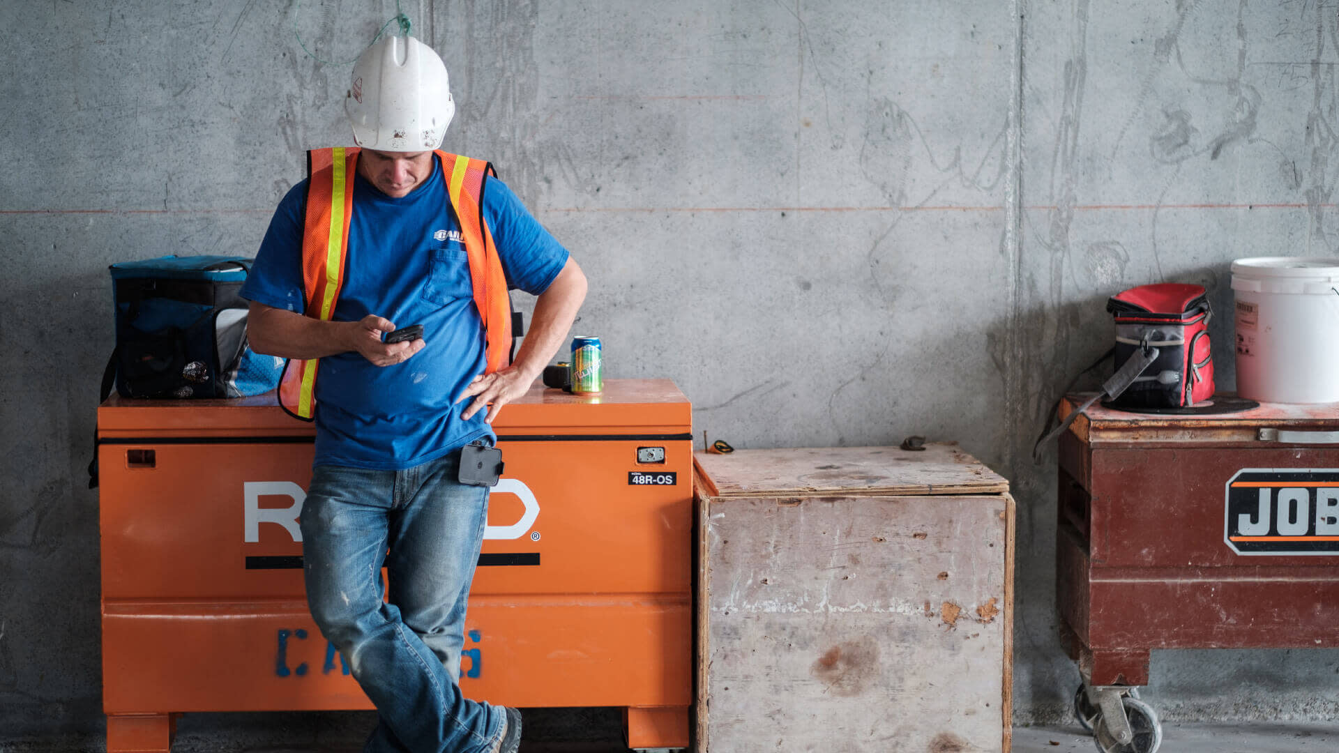 Construction worker using Procore on his phone