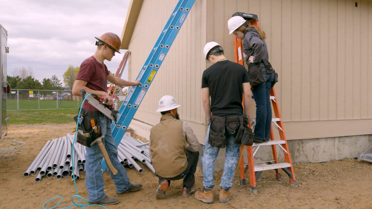 Contractor teaching students on site