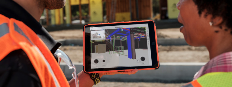 Construction worker using BIM on an iPad at a jobsite