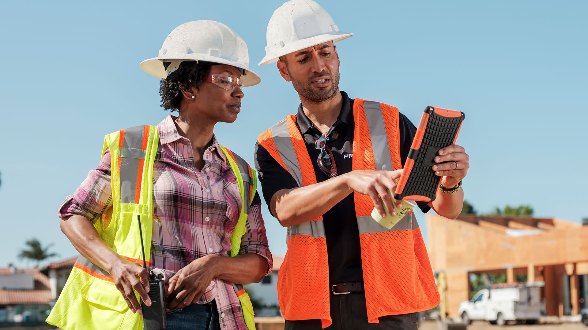 Contractors making a decision while reviewing their project on an ipad