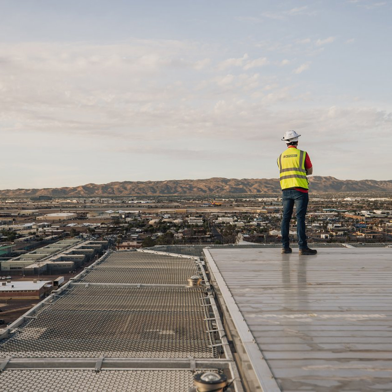 A construction worker standing on a rooftop