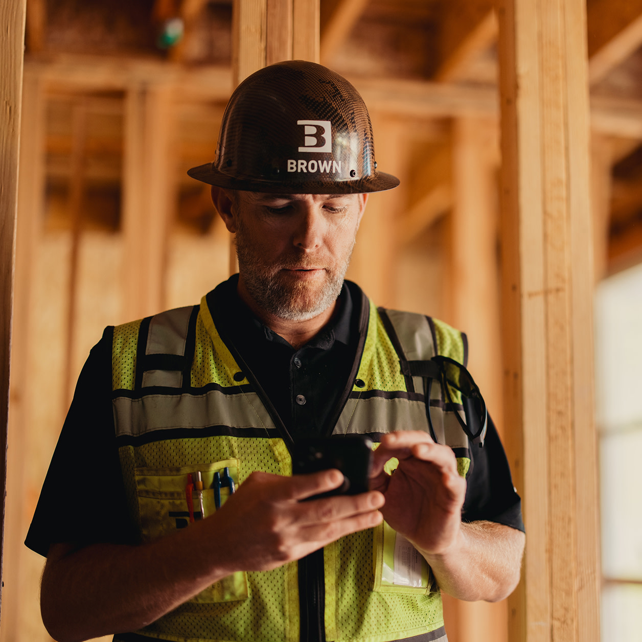 A construction worker using a phone on site