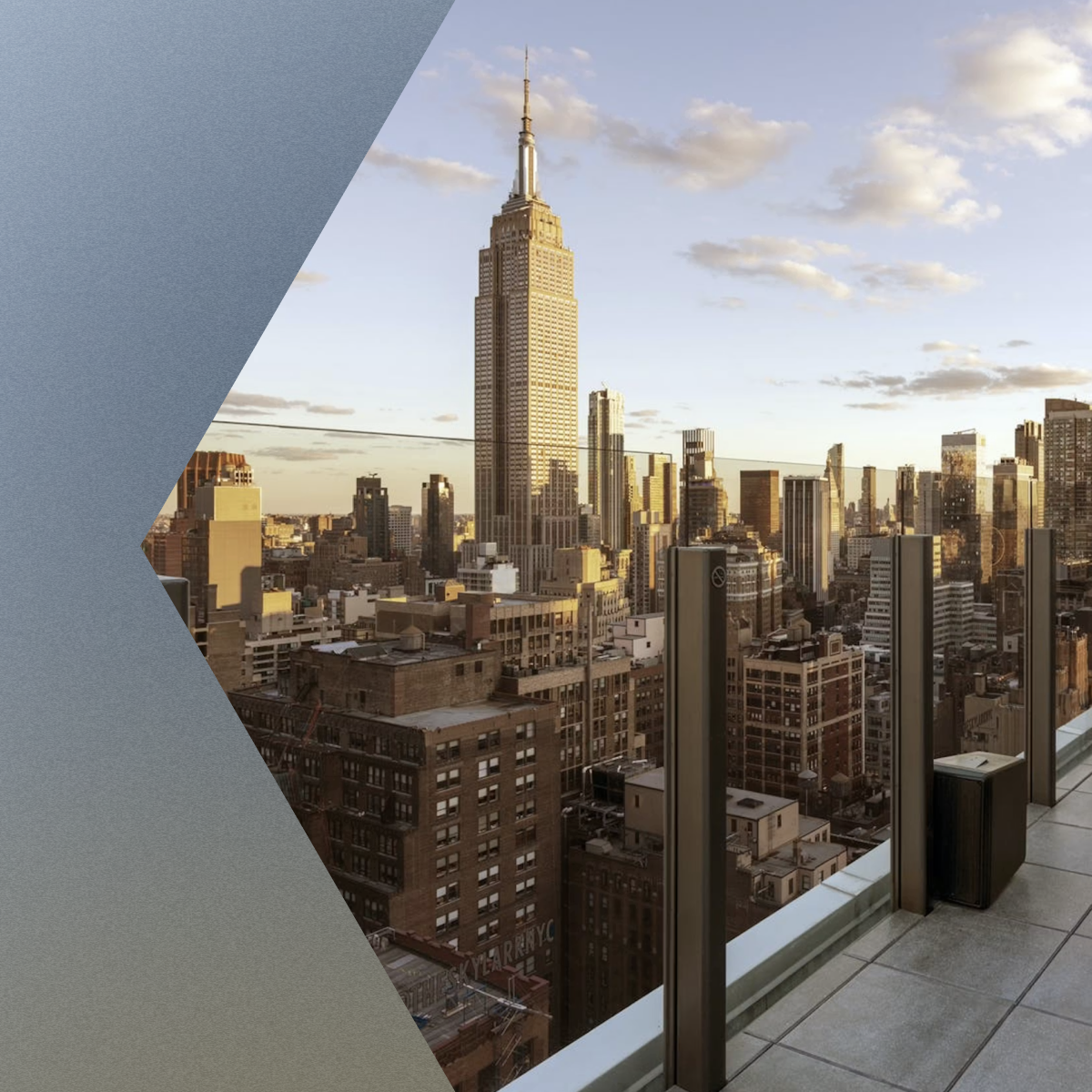 New York City skyline with Empire State Building viewed from rooftop terrace at sunset.