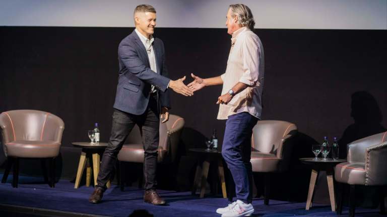 Tooey Courtemanche and Fren Mills' shaking hands