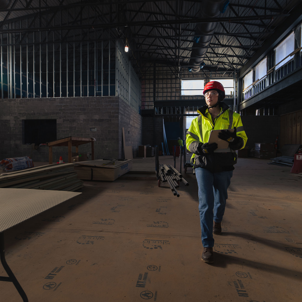A woman contractor walking on a construction site