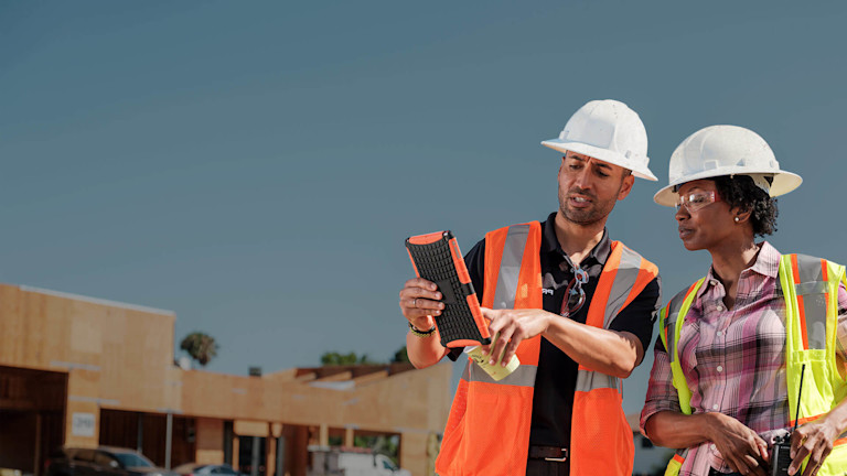 Workers using a tablet on a jobsite