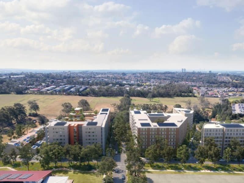 Aerial render showing Stage 1 of the West Glenfield Precinct comprising 120-unit affordable block (left) and future apartments and terraces (right).