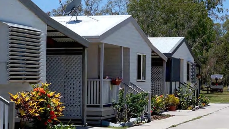 image of three modest cabins in a caravan park 