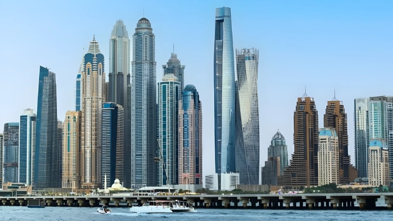 image of towers in the main street of dubai including the eye of the needle shaped tower