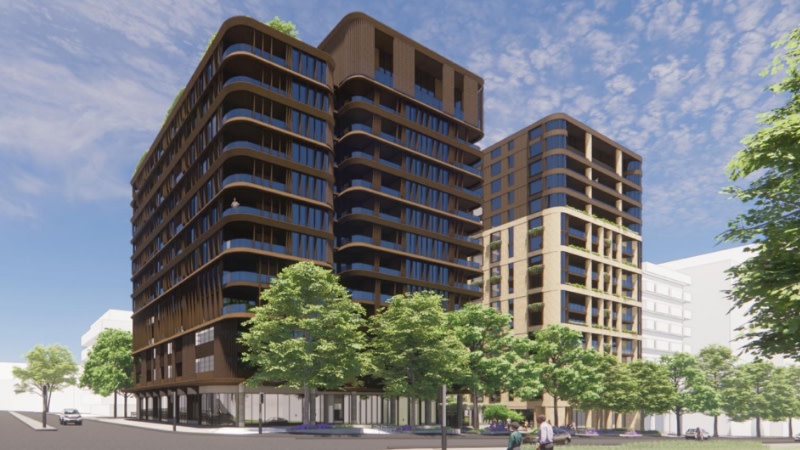 rendering of two buildings in brown and beige with trees around the base