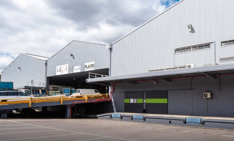 Existing warehouse structures and loading docks on the site at 41 Roberts Road in Greenacre, NSW that Goodman Property wants to redevelop into four new warehouse and office buildings.