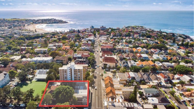 aerial image showing a parcel of land and houses outlined in red and Bondi Beach in the distance.