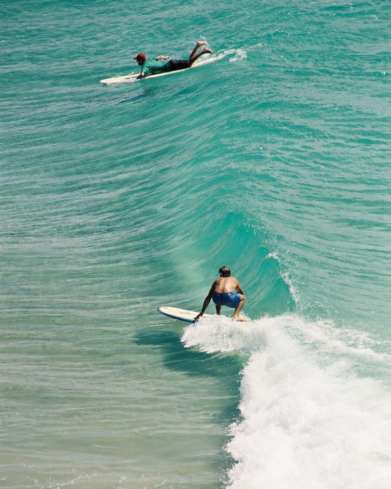 Surfers catch a wave.  The 4400-sq-m development site is a little more than a kilometre from the famous surfing spot.