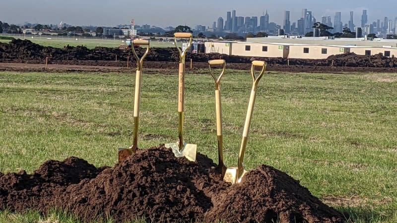 Golden shovels used in the sod turning ceremony sit in front of the early works already underway on the site at Essendon Fields precinct north of the Melbourne CBD.