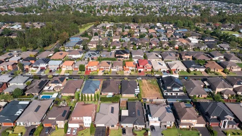 Aerial view of the rooftops of suburban houses.