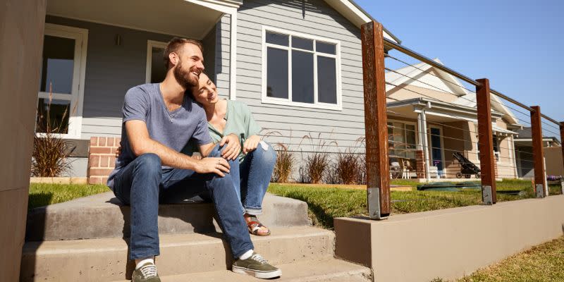 A couple sit outside a home at Huntlee community near North Rothbury, NSW. 