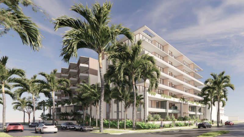 render of two seven storey apartment buildings in a beachy, white design surrounded by palm trees.