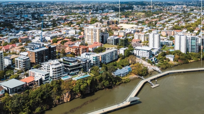 brisbane city and new farm looking at the river winding through the middle of the image.