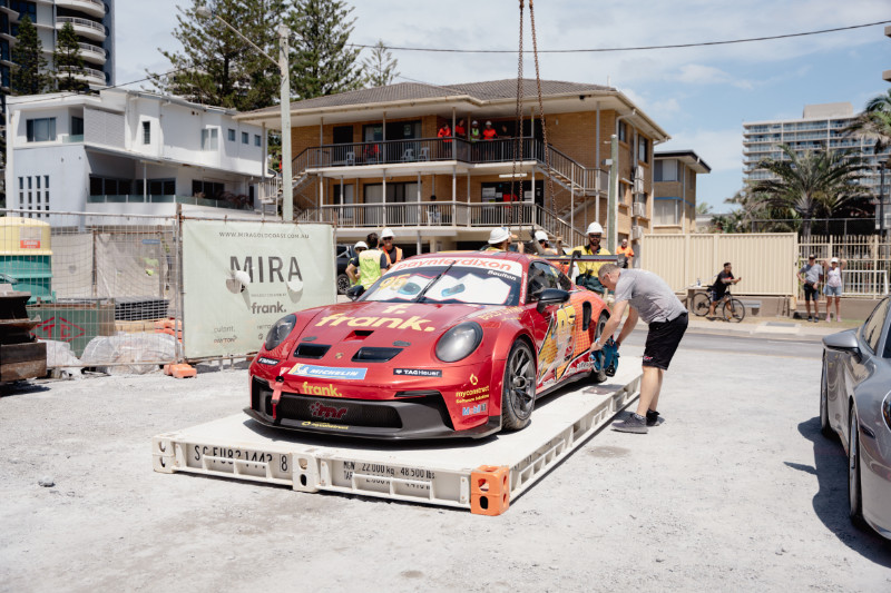 Crew members prepare to lift Brett Boulton’s Porsche GT3 Cup car at Frank Developments’ MIRA site on Northcliffe Beach.