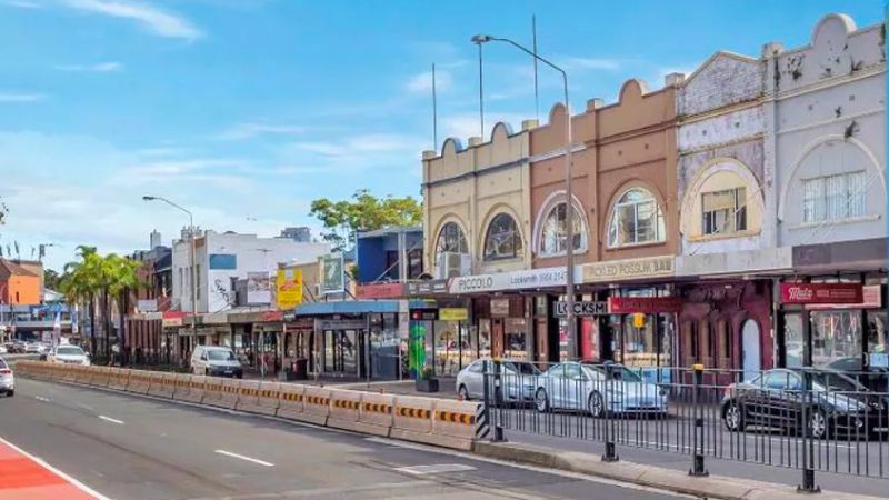 Existing shops on Military Road Neutral Bay are along a busy street and have traditional brick facades on two storey buildings.