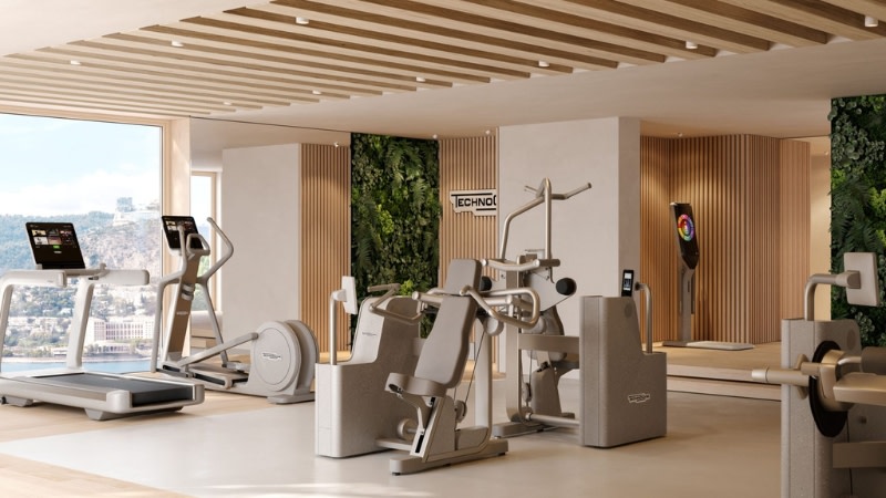a modern gym with fitness machines and digital offering in a premium development