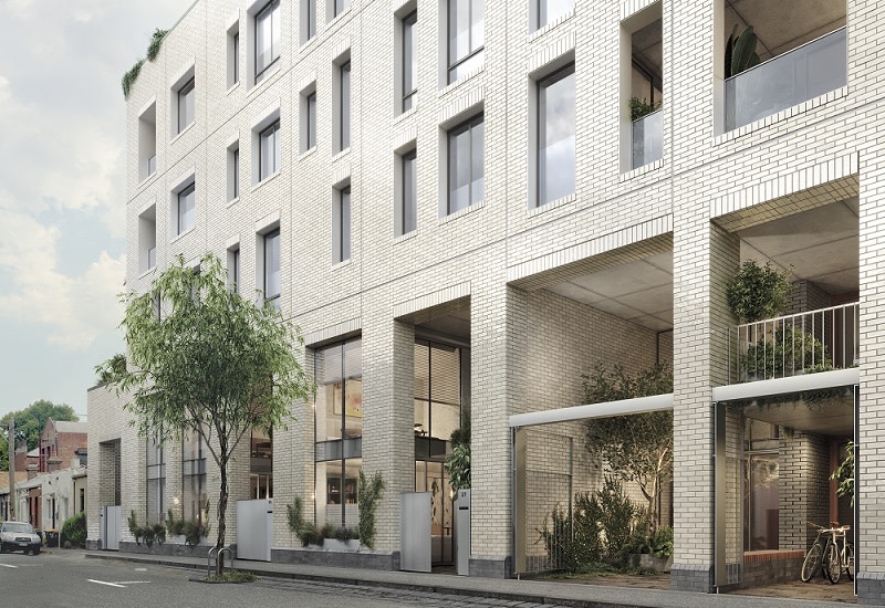 outside the lower levels of the Otter Place development with townhouses and an office on the lower floor. The podium is covered in light coloured bricks.