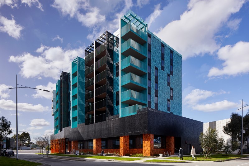 An image of a building with blue, black and orange facades, a social housing project by Launch Housing.