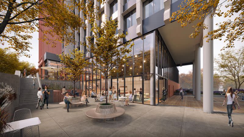 The lower levels of the coliving development on Herring Road, Macquarie Park show people intereacting in an open indoor and outdoor area.