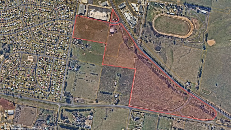 aerial image of undeveloped land in Orange highlighted in red which would be turned into a new housing development.