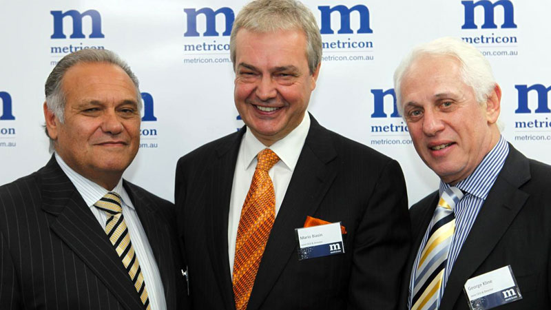 Metricon’s acting executive chair Ross Palazzesi and chief executive and founder, the late Mario Biasin alongside George Kline.
