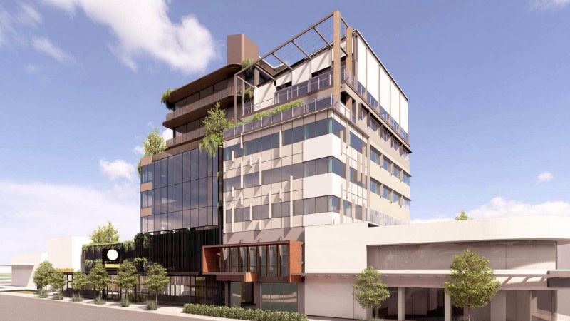 rendering of an office development with a light half and dark half and large ground floor retail area.