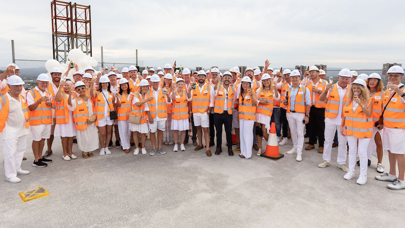 The McNabb team and White residents-to-be celebrate the topping out of the Main Beach project.