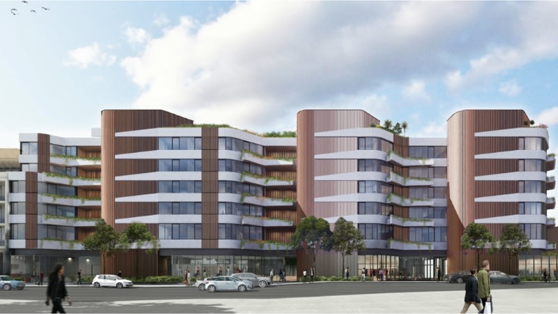 a side view of the gurner development which is long a six storey apartment building.