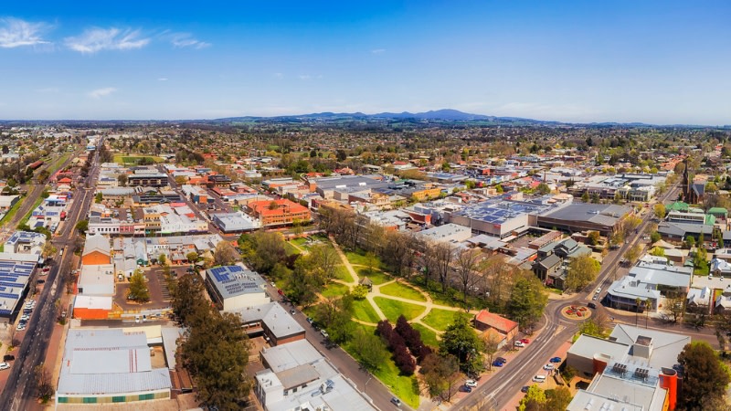 Orange city in Australian Western plains on a sunny day above downtown and central city park.