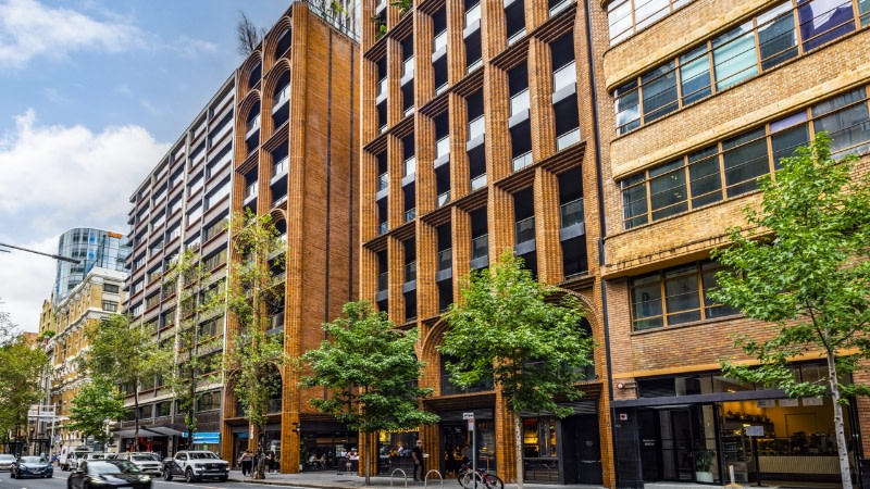 looking down the street to the sky suites hotel at all the brick buildings in the sydney cbd.