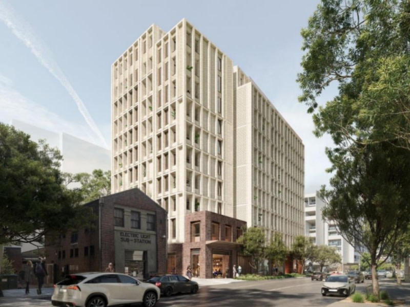 rendering of an 11 storey white apartment block in sydney next door to an old brick electric light sub station.