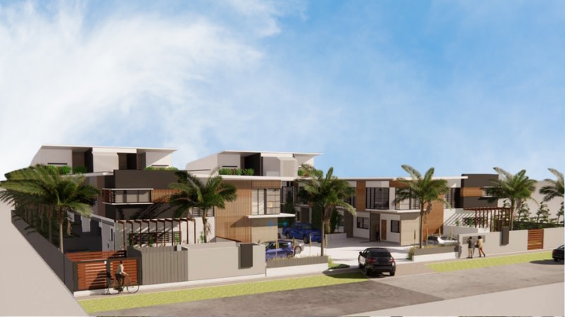 multiple townhouse style buildings surrounded by palm trees 