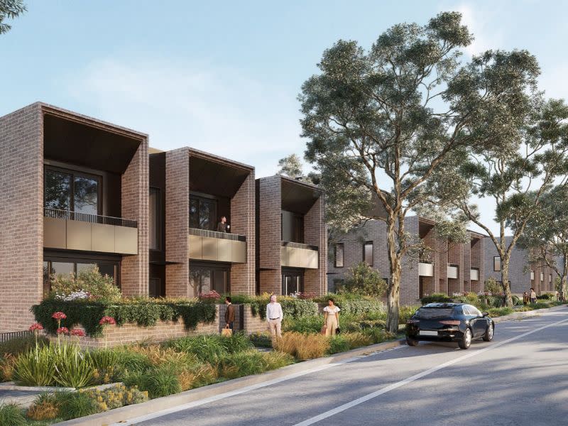 Render of view from O'Connell Street showing a row of brick residential blocks like terraces.