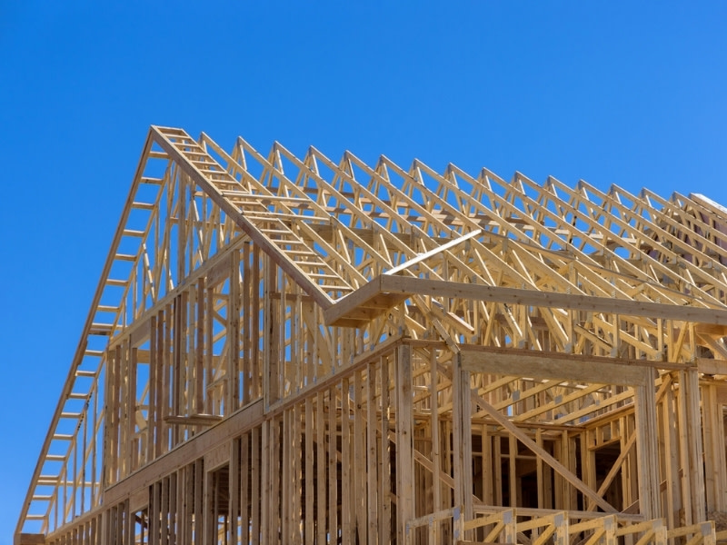A photograph of the timber frame of a house under construction.