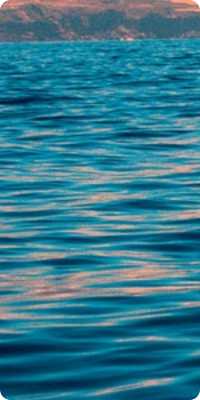 A sailboat sailing in a calm ocean with a good weather