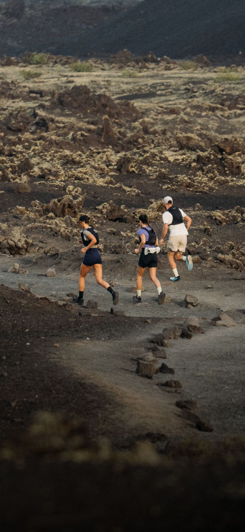 Woman in blue sportswear and man in pink shirt running energetically against a plain white background. (1)