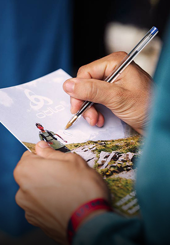 An Odlo athlete giving an autograph