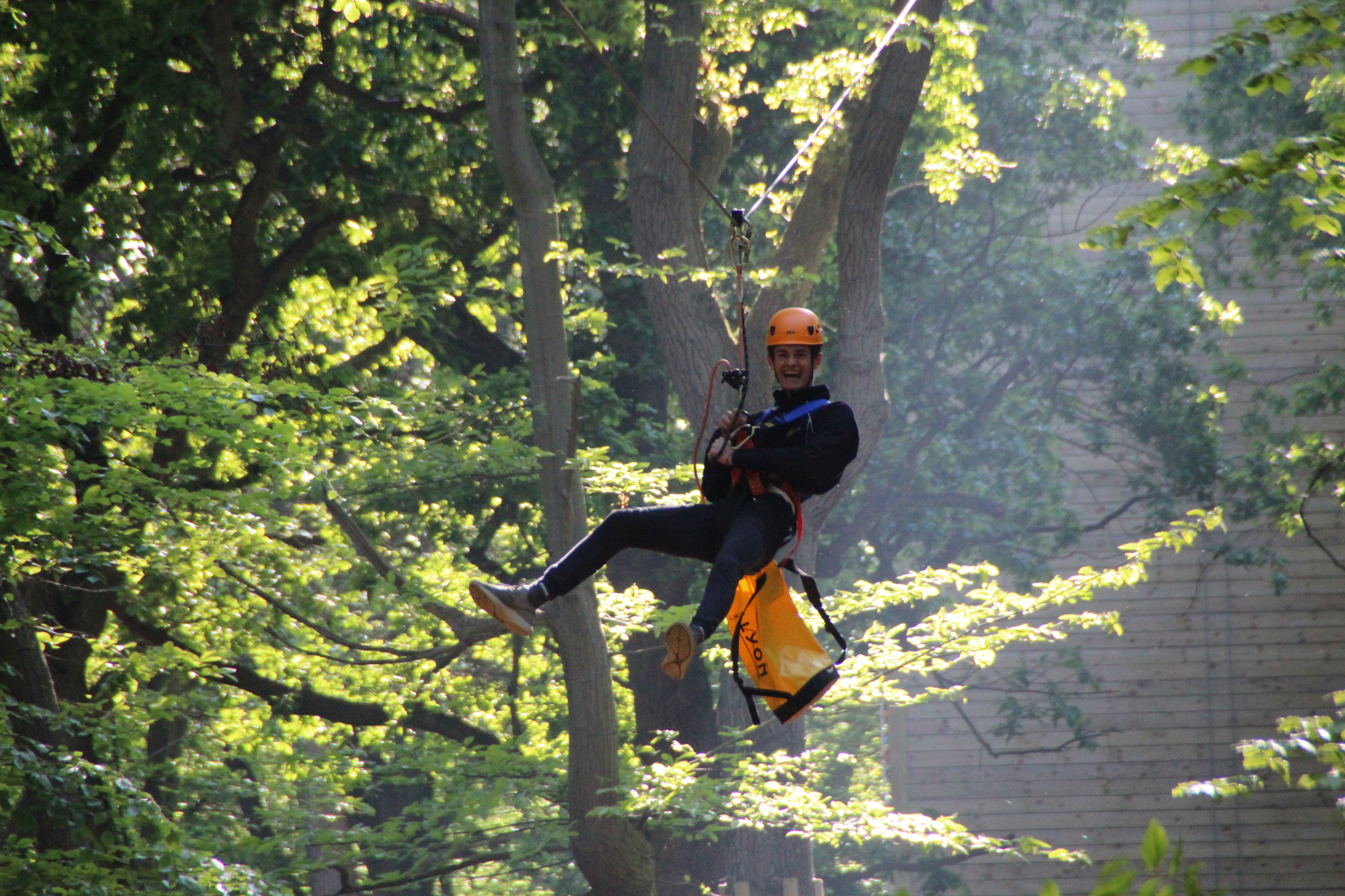 Gresham's School - student at the Outdoor Activity Center hanging on the High Ropes