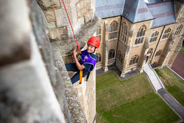 Malvern Summer School - Schueler wird von historischem Schulgebaude abgeseilt Malvern Summer School - Schueler wird von historischem Schulgebaude abgeseilt